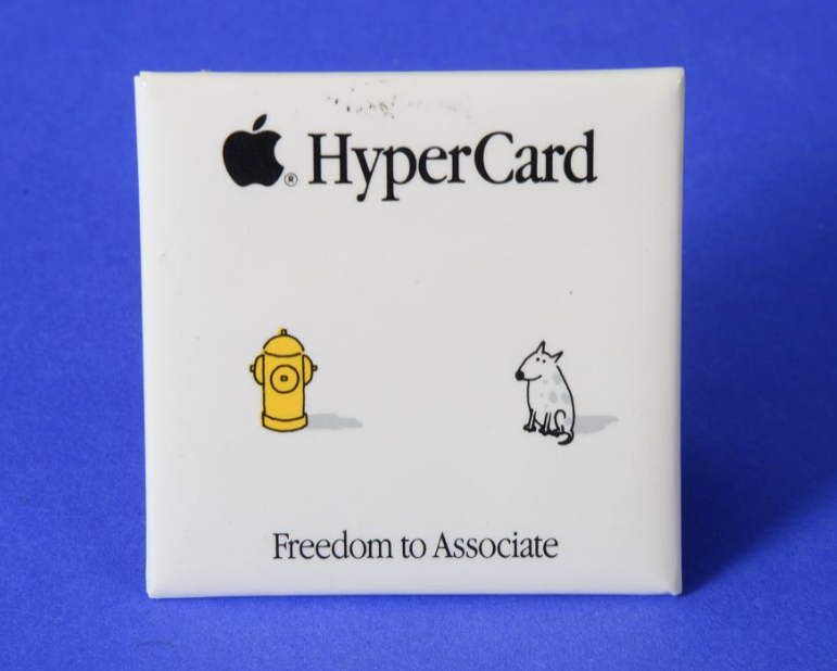 A HyperCard promotional square pin showing a minimalist illustration of a fire hydrant and a dog separated by white space, with the slogan “Freedom to Associate.”