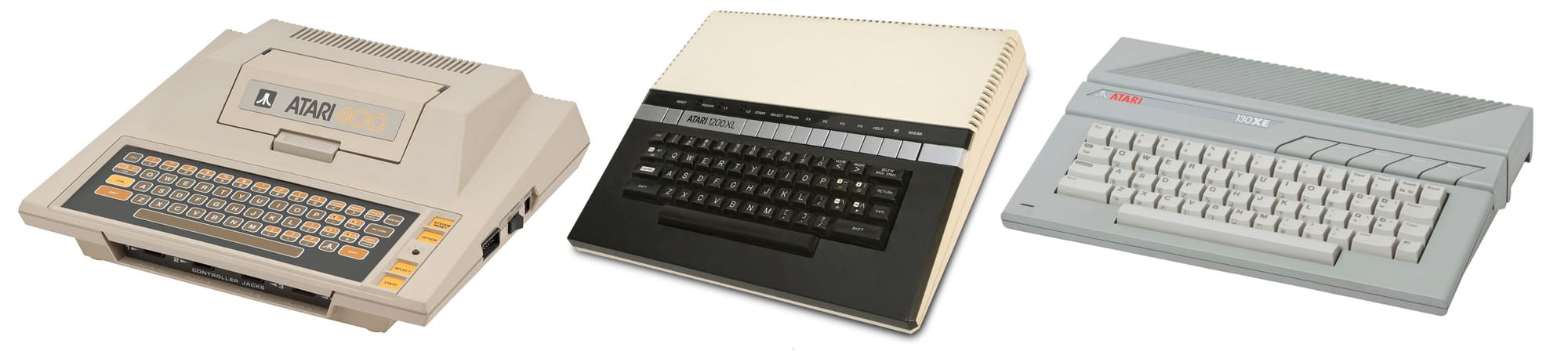 Three Atari 8-bit systems, each from a different industrial design era. From left, the original Atari 400 with membrane keyboard, in beige with orange highlights. Next, the Atari 1200XL, in tan and black with chrome F-Key buttons. On the right, in grey plastic with off-white keys is a 130XE.